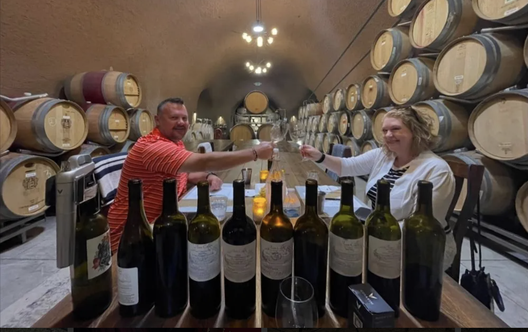 Two guests toasting in the barrel cellar